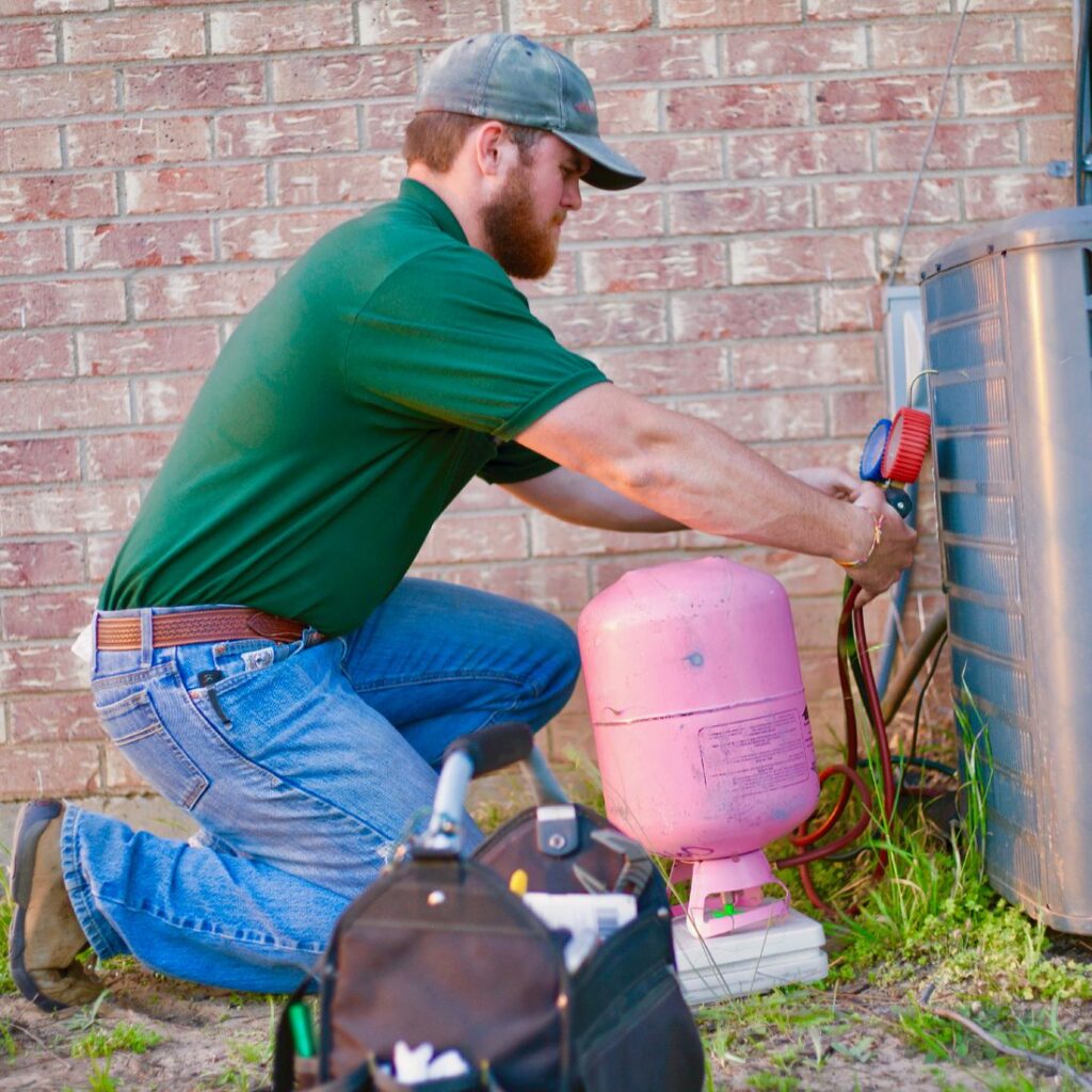 AC Genius HVAC technician servicing an air conditioner at a Carrollton, TX home