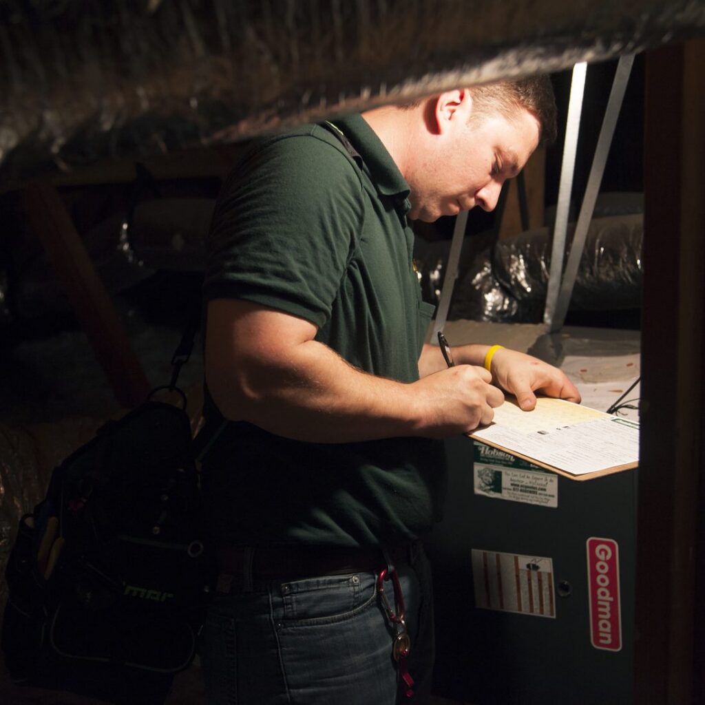 AC Genius HVAC technician servicing an air conditioner at a Denton, TX home